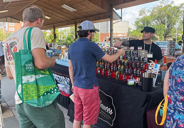 James selling hot sauce at a local farmer's market